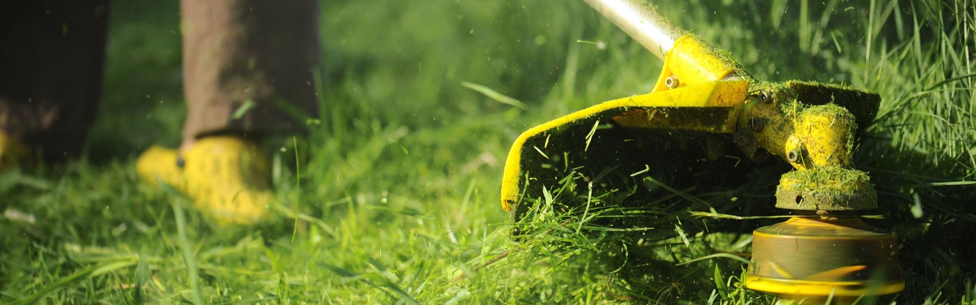 Closeup photo of weedwhacker doing commercial landscaping