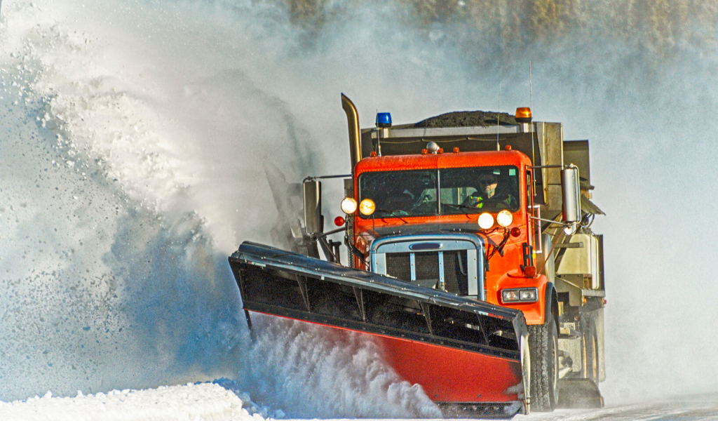 Snow Plow Truck Removing Snow From Roadside